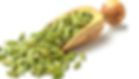 Green cardamom pods in a wooden scoop