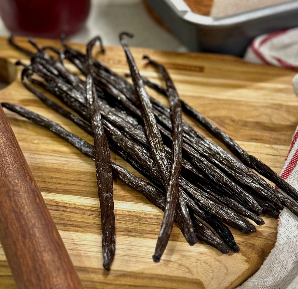 Vanilla beans on a wooden cutting board with a striped cloth nearby. A cozy, rustic kitchen setting, evoking a warm, inviting mood.