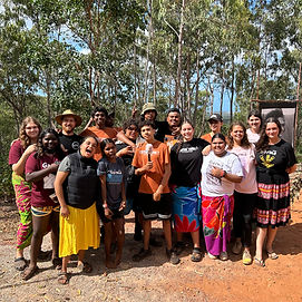 A group of young Aboriginal and Torres Strait Islander students and leaders smiling together for a photo. One of them holds an NITV microphone. The group exudes pride and unity.