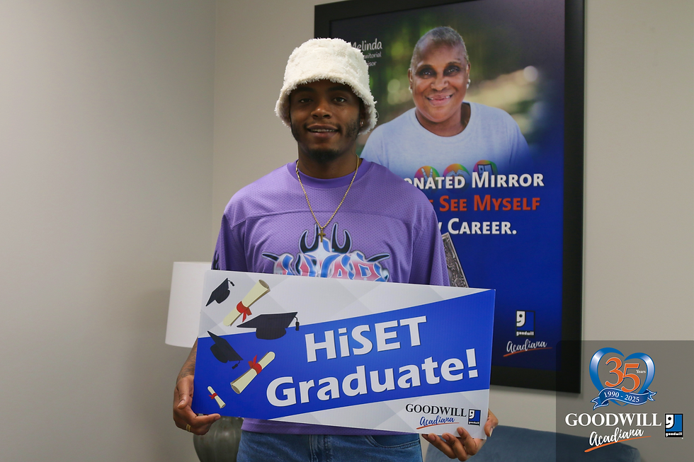 Markel holding the Goodwill Acadiana HiSET Graduate sign