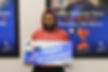 Goodwill Acadiana adult HiSET education graduate Jalen holding his graduate sign