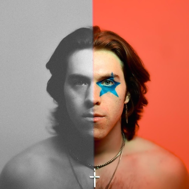 Split portrait of a shirtless person, half black-and-white and half red-tinted, with a blue star over one eye and a cross necklace.