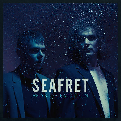 Two people stand in a dark, snowy blue setting, wearing dark jackets. Text reads "SEAFRET" and "FEAR OF EMOTION" in bold letters.