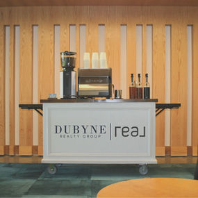 Coffee cart catering setup in Vancouver WA and Portland OR featuring custom branded cups and signage at a corporate event, with baristas serving espresso drinks to guests.