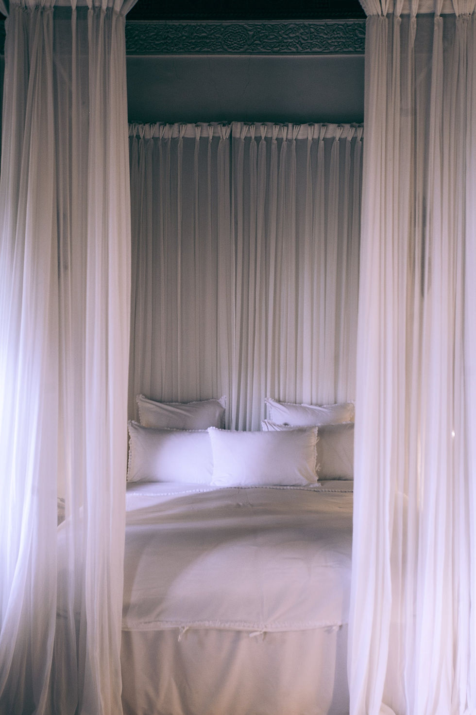 White bed with curtains