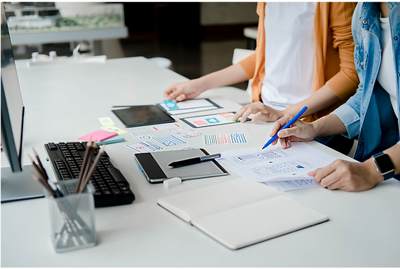 Developers collaborating on custom software solutions, reviewing wireframes and technical plans during the white-label software development process.