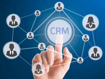 An image of a hand touching a CRM button surrounded by a network of other people.