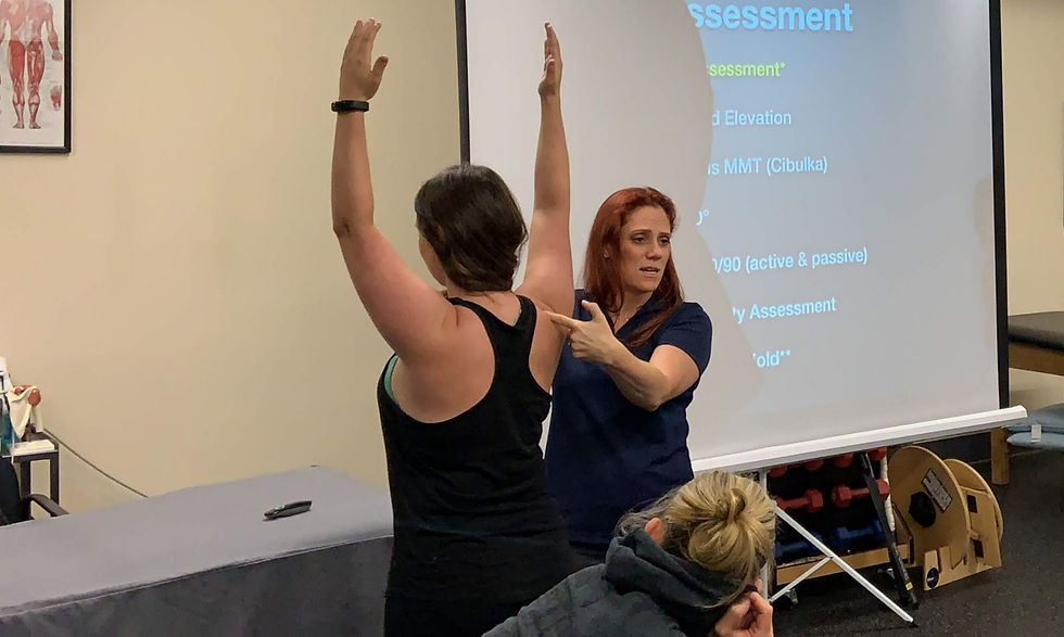 Eye-level view of a physical therapist demonstrating shoulder mobility exercises with a patient
