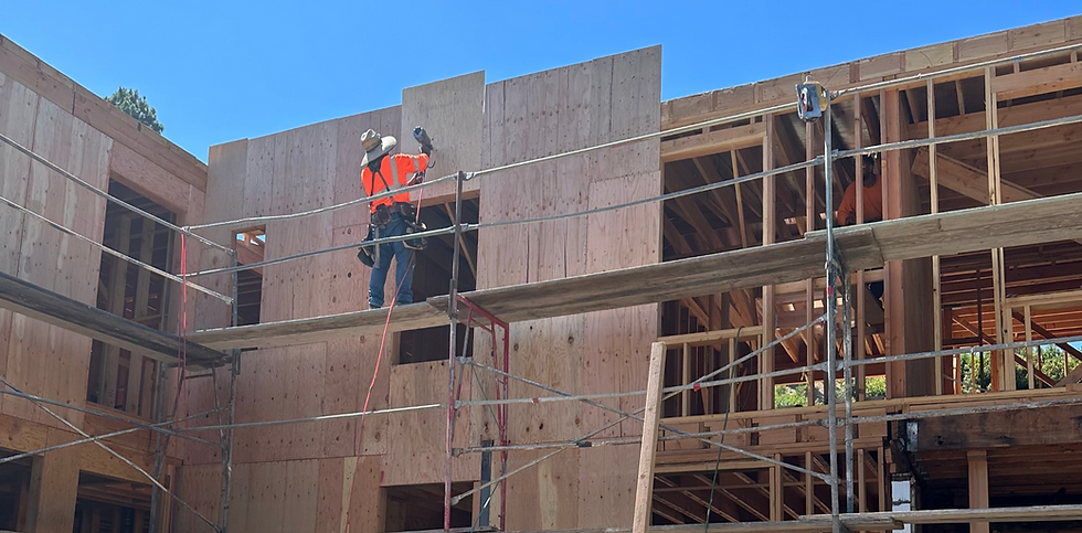Construction site building a new home with a construction worker working on framing