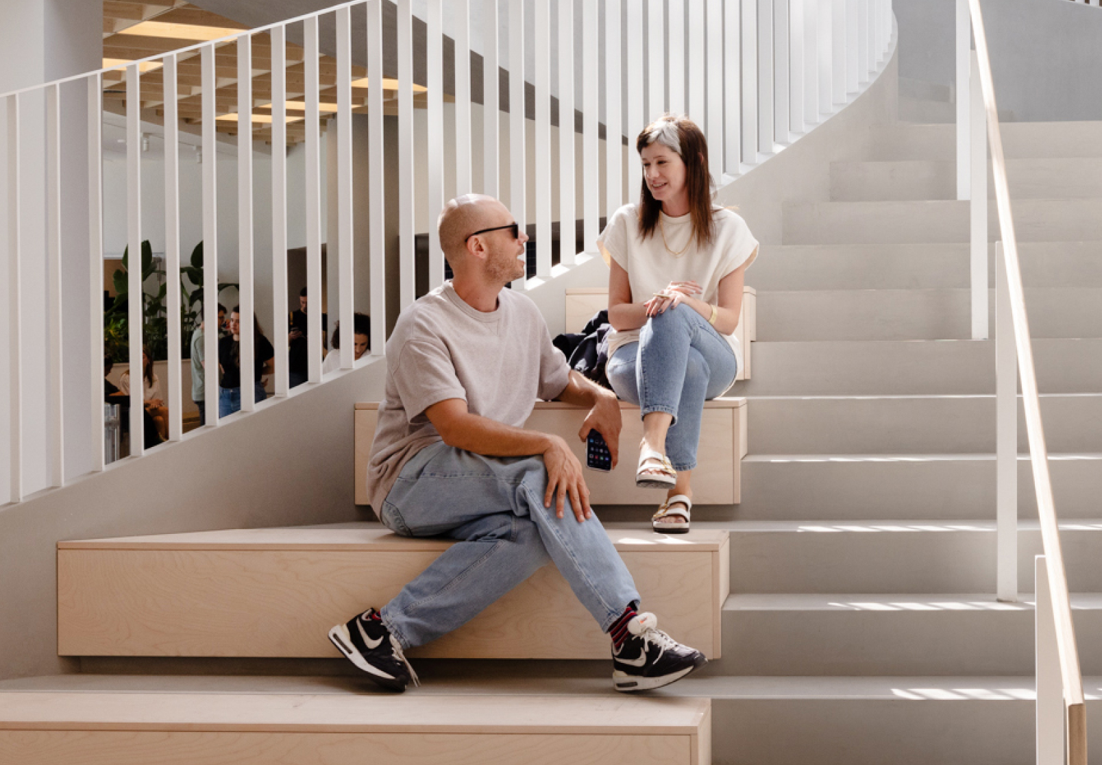 A man and a woman having a discussion on a staircase. 