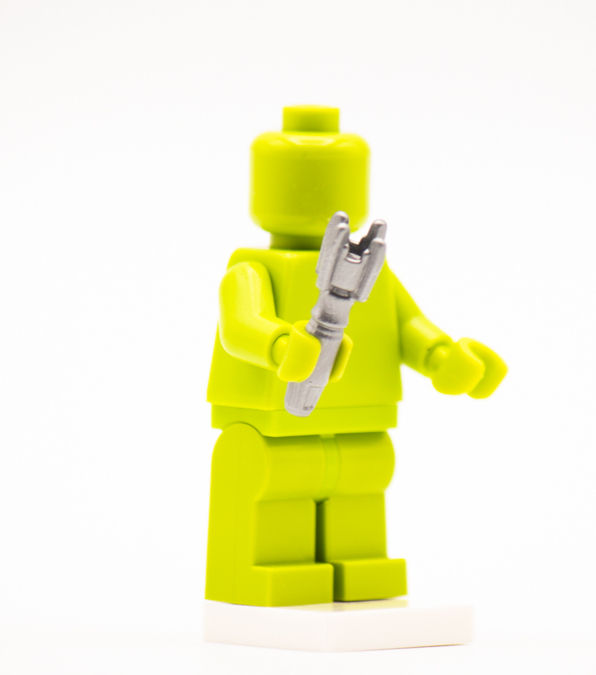 Thumbnail: Lime green minifig holding a silver tracking fob