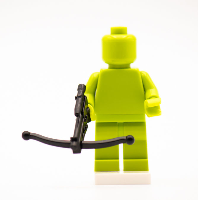 Thumbnail: Lime green building brick figure holding a black Bowcaster Blaster 