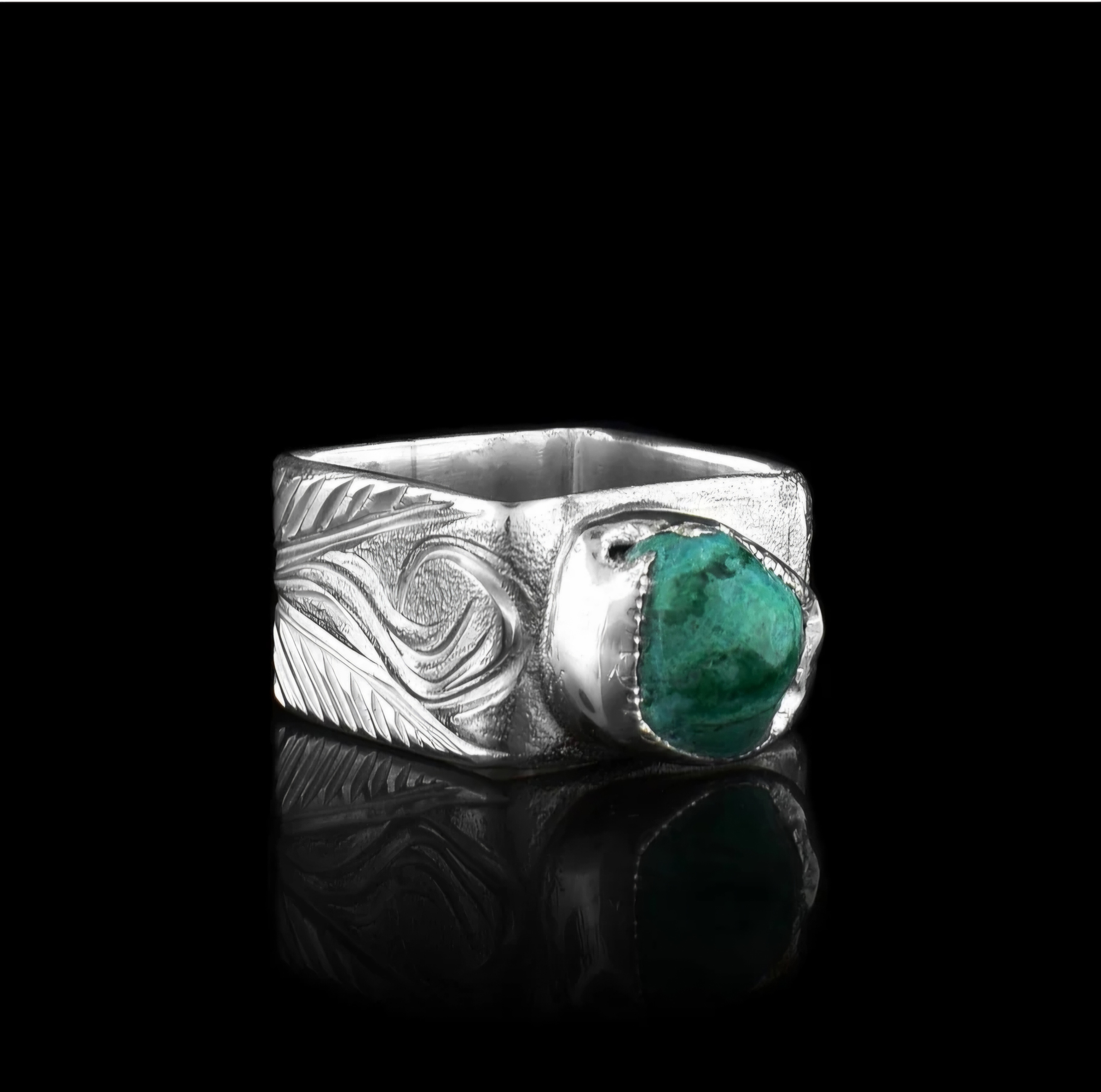 Silver ring with turquoise stone and feather design