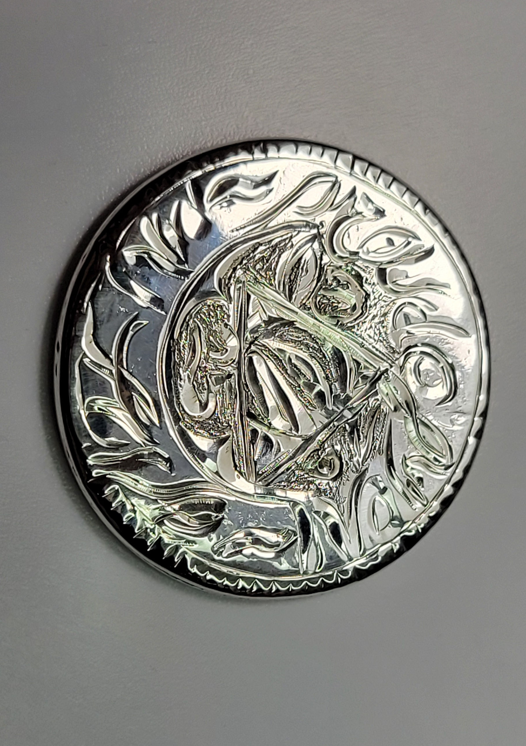 Shiny silver coin with intricate design, details and unique details. One-of-a-kind Coin.