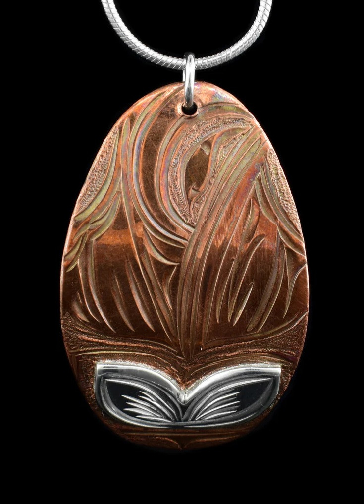 Thumbnail: Intricate copper pendant with etched design