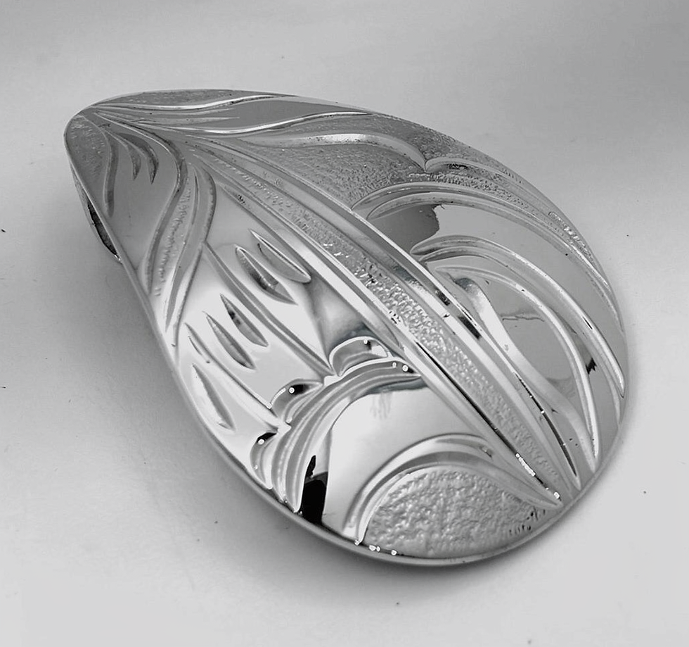 Thumbnail: Detailed silver carved pendant with elegant flowing patterns.