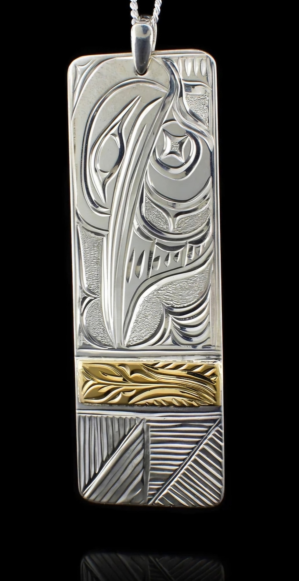 Thumbnail: Intricate silver and gold Tui pendant: LivingIndigenousArt