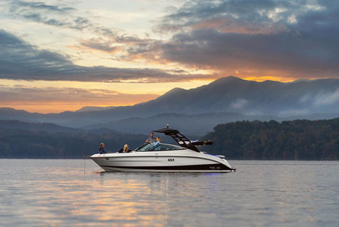 Sea Ray boating on lake near Knoxville, Tennessee during sunrise