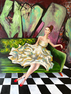 beautiful woman in a fluffy white dress wearing red shoes sitting on a retro style green couch with a graffiti covered wall in the background and black and white tile wall. 