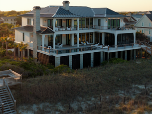 Exterior drone shot of a luxury beach home