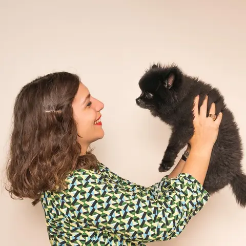 Chani Ronez founder of merci collective playing with her dog