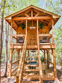 Two-story cedar fort with pitched roof and plant boxes, custom-built in Atlanta to inspire play, creativity, and connection.