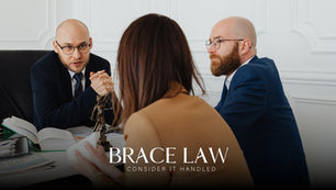 Family law consultation with lawyers speaking to a client about separation and spousal support at a desk.
