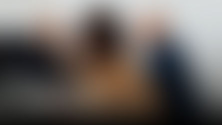 Family law consultation with lawyers speaking to a client about separation and spousal support at a desk.