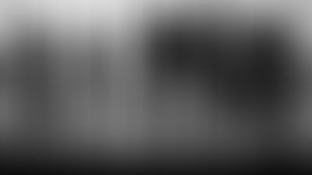 Business professionals standing in an office with a city view, representing skilled workers eligible for Canada’s Significant Benefit Work Permit.