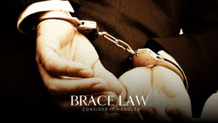 Hands of an alleged criminal handcuffed by the police.