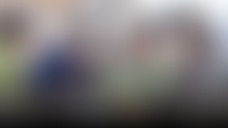 Parents and Grandparents spending time together reading book a child