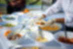 Caterers preparing a taco to serve a guest