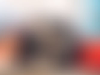 Mechanic inspecting a large truck tire in a workshop.