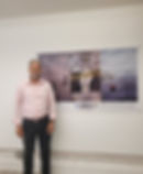 Luis Leon/Artist in front of his banner