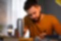 ​Man sitting at a desk with a beverage in his hand. Taurine is a key ingredient in energy and sport drinks for increased mental alertness and improved endurance performance.