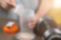 Person making a nutritional beverage. Taurine, a longevity vitamin, promotes health of immune system, heart, muscle, and microbiome.