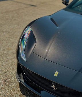 Dark grey Ferrari car, wax ceramic coating