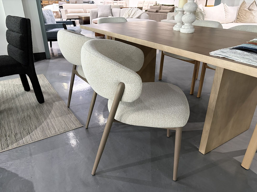 Thumbnail: Nancy boucle dining chairs around light wood dining table in bright contemporary kitchen with neutral decor.