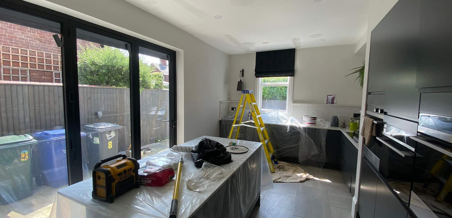 Sleek modern kitchen under repair and upgrade after water damage, part of BMJ Property's property maintenance services