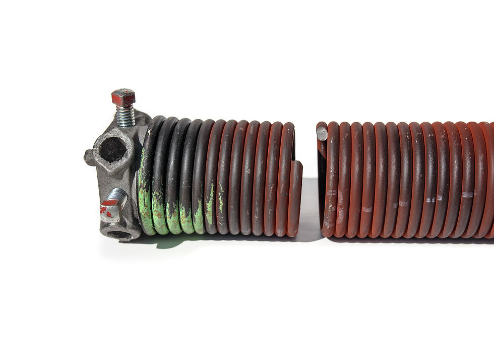 Broken garage door spring or torsion spring from overhead sectional door. Sheared-off spri
