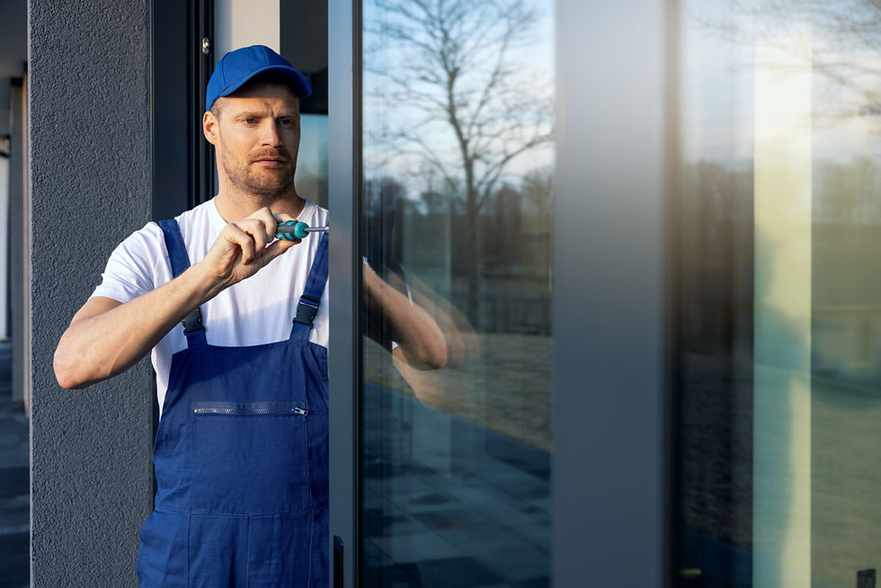 worker installing and adjusting aluminum frame sliding terrace doors.jpg
