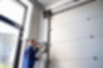 Garage Door Installation And Repair At Home. Contractor Man In House.jpg