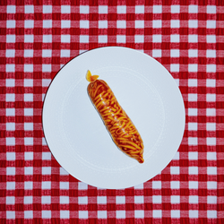 Food Porn by Mishele — a condom filled with spaghetti bolognese on a white plate and red gingham.