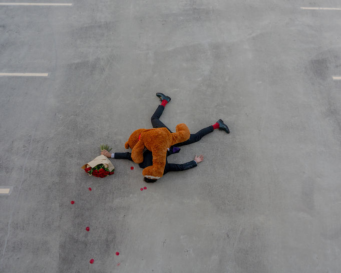 The End by Mishele — a fallen figure beneath an oversized teddy bear and bouquet.