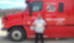 Nathan holds his CDL-A certificate while standing in front of a bright red Road Warrior Truck Driving School semi.