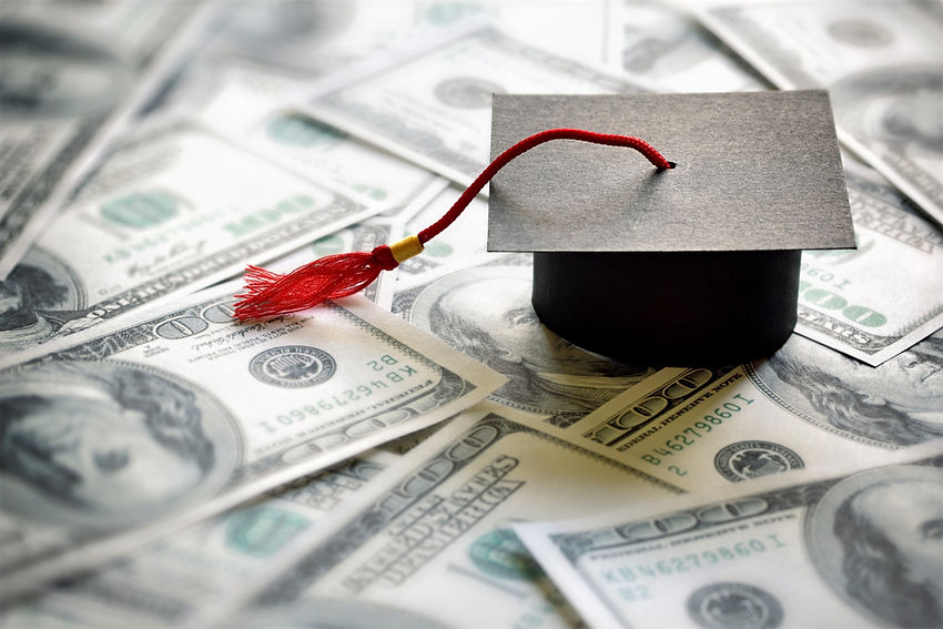 graduation cap set on 100 dollar bills