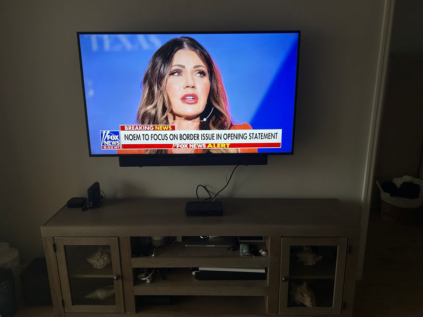 65 inch TV mounted above a stand in Fort Myers FL. 