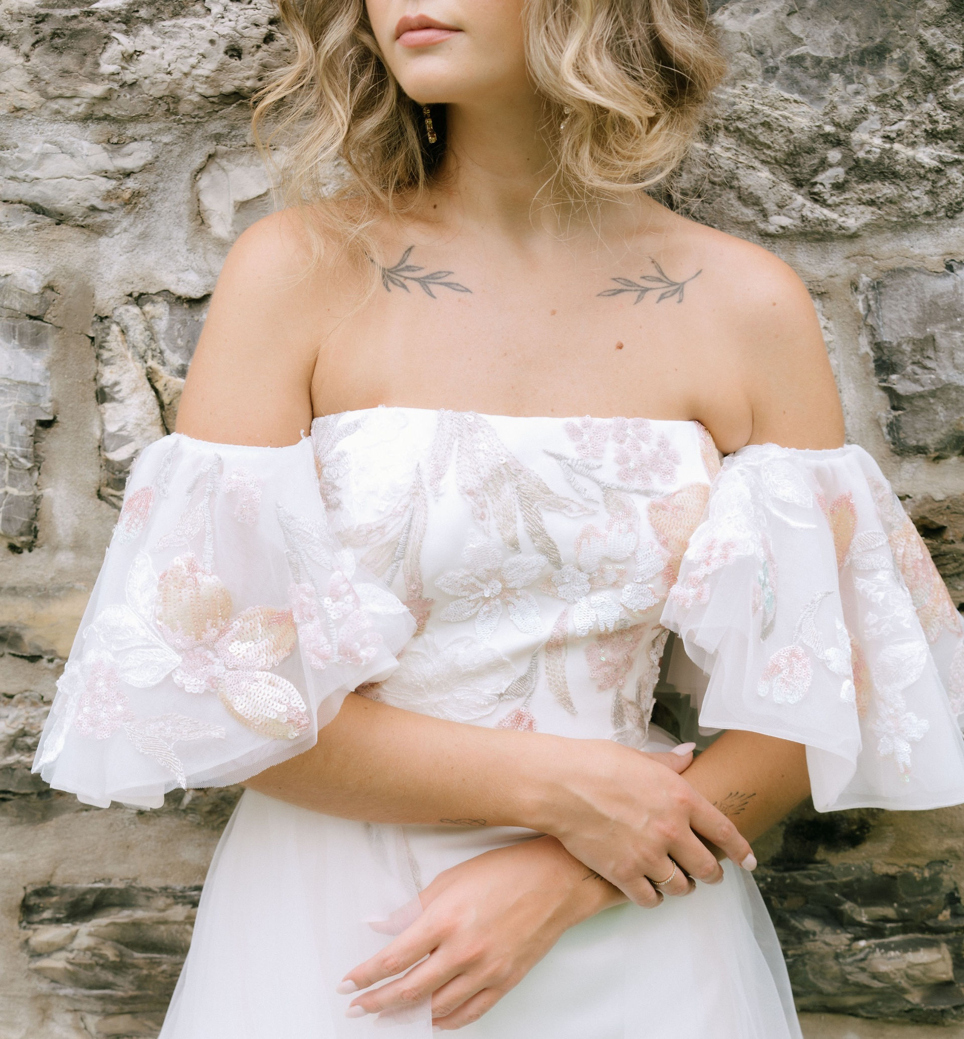 strapless wedding dress with detachable sleeves and blush floral sequin details
