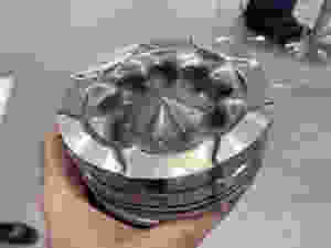 Piston with flame front optimized surface for optimal efficiency by OERLIKON