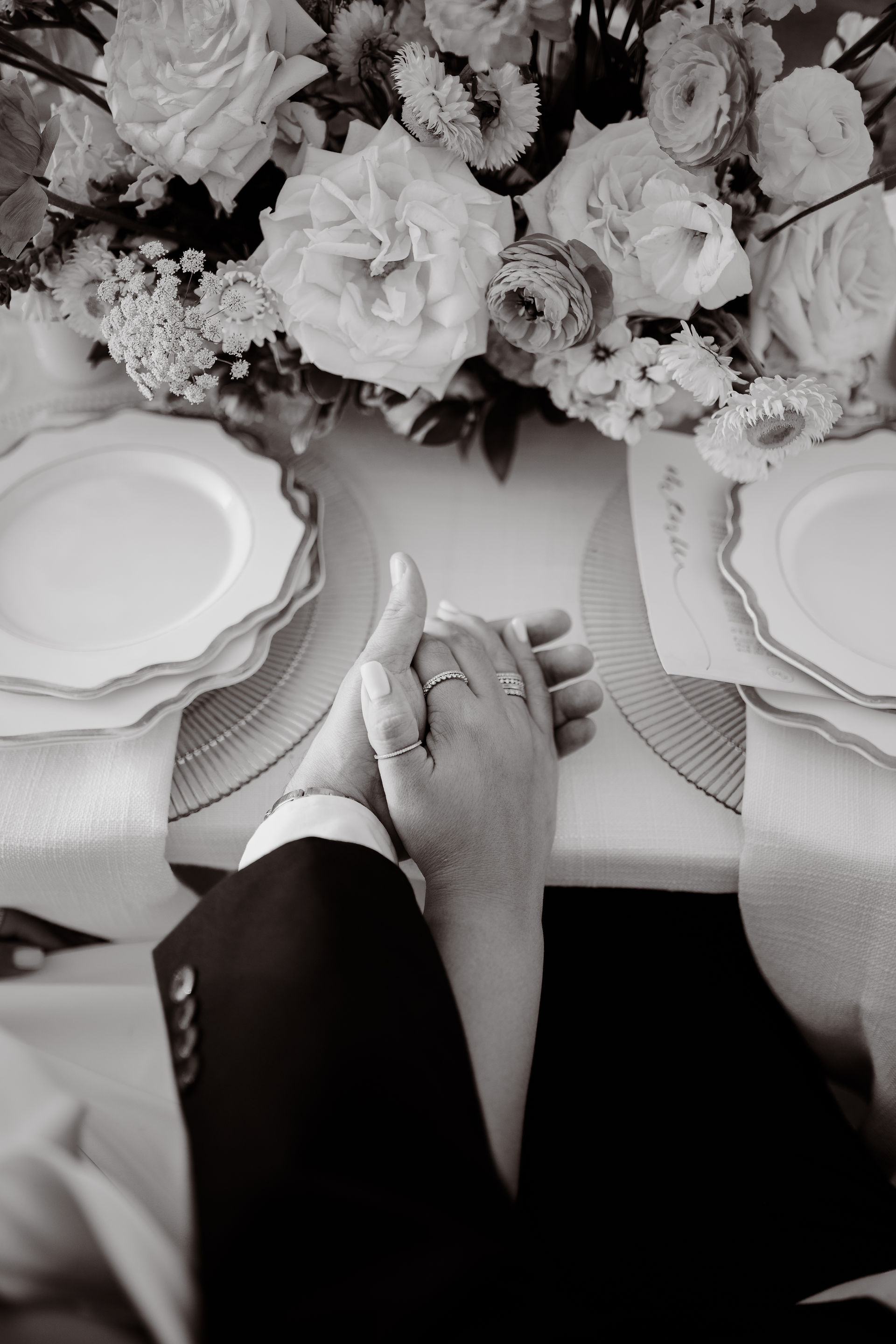 Close-up of couple’s hands intertwined 